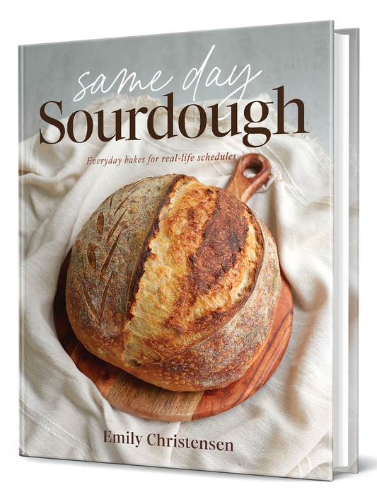 Book titled 'Same Day Sourdough' by Emily Christensen with a loaf of bread on the cover.