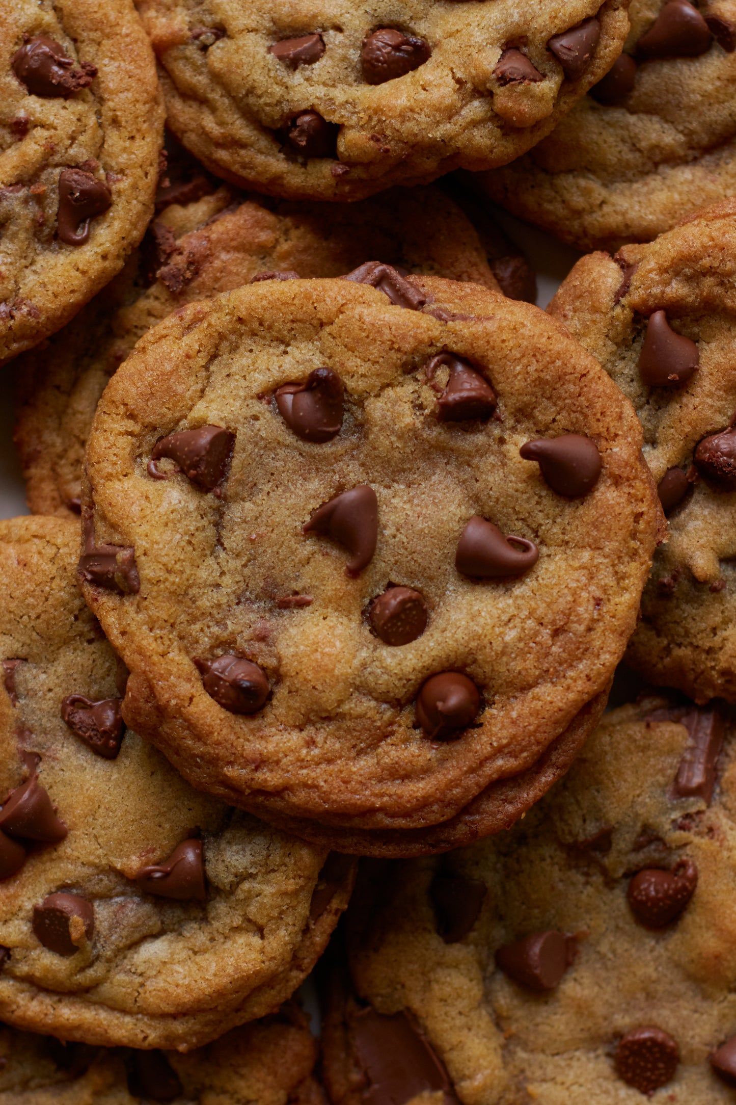 Stack of sourdough brown butter chocolate chip cookies for same day sourdough cookbook. 