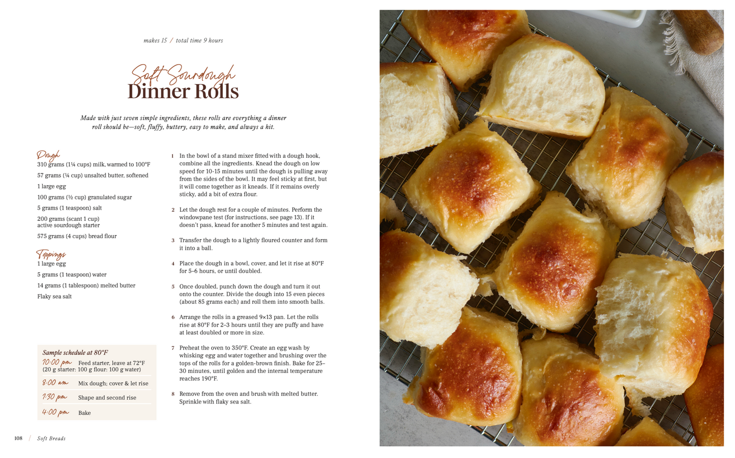 Baked sourdough dinner rolls on a cooling rack with a recipe on the left side for sourdough dinner rolls from same day sourdough cookbook. 